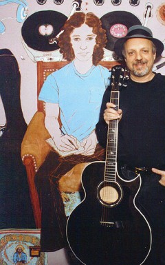 Kenny Weissberg beside a portrait his wife, Helen Redman, painted in 1972